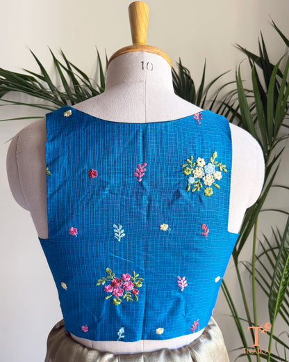 Back view of premium Kota silk blouse with delicate floral embroidery and elegant tailored finish.