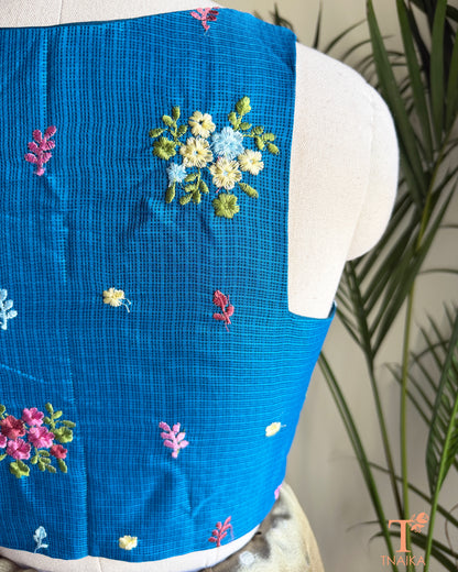 Close-up of floral embroidery detailing on premium Kota silk blouse showcasing handcrafted artistry.