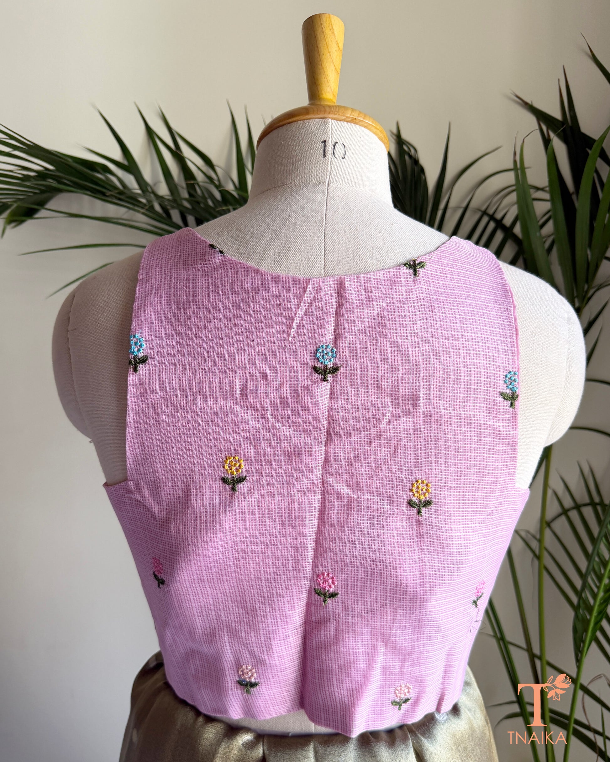 Back view of premium Kota silk blouse with delicate floral embroidery and elegant tailored finish.