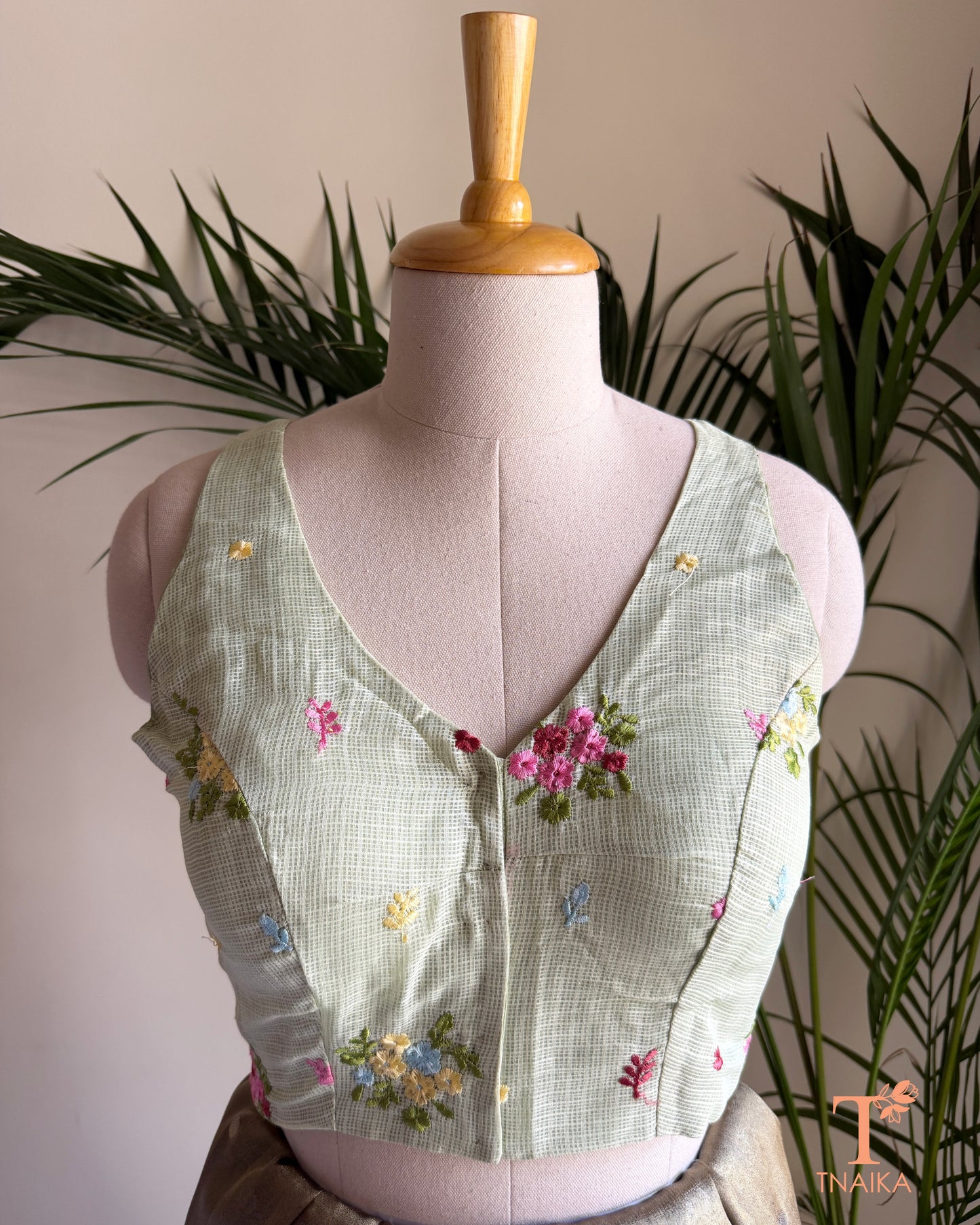 Front view of embroidered Kota silk blouse featuring a flattering V-neckline and intricate floral embroidery detailing.