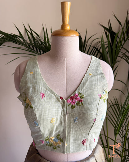 Front view of embroidered Kota silk blouse featuring a flattering V-neckline and intricate floral embroidery detailing.