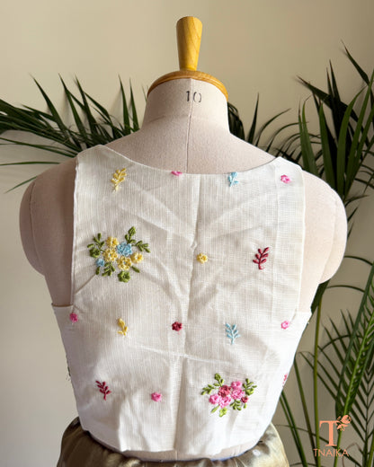Back view of premium embroidered Kota silk blouse featuring delicate floral motifs, soft pastel embroidery, and a structured tailored finish.