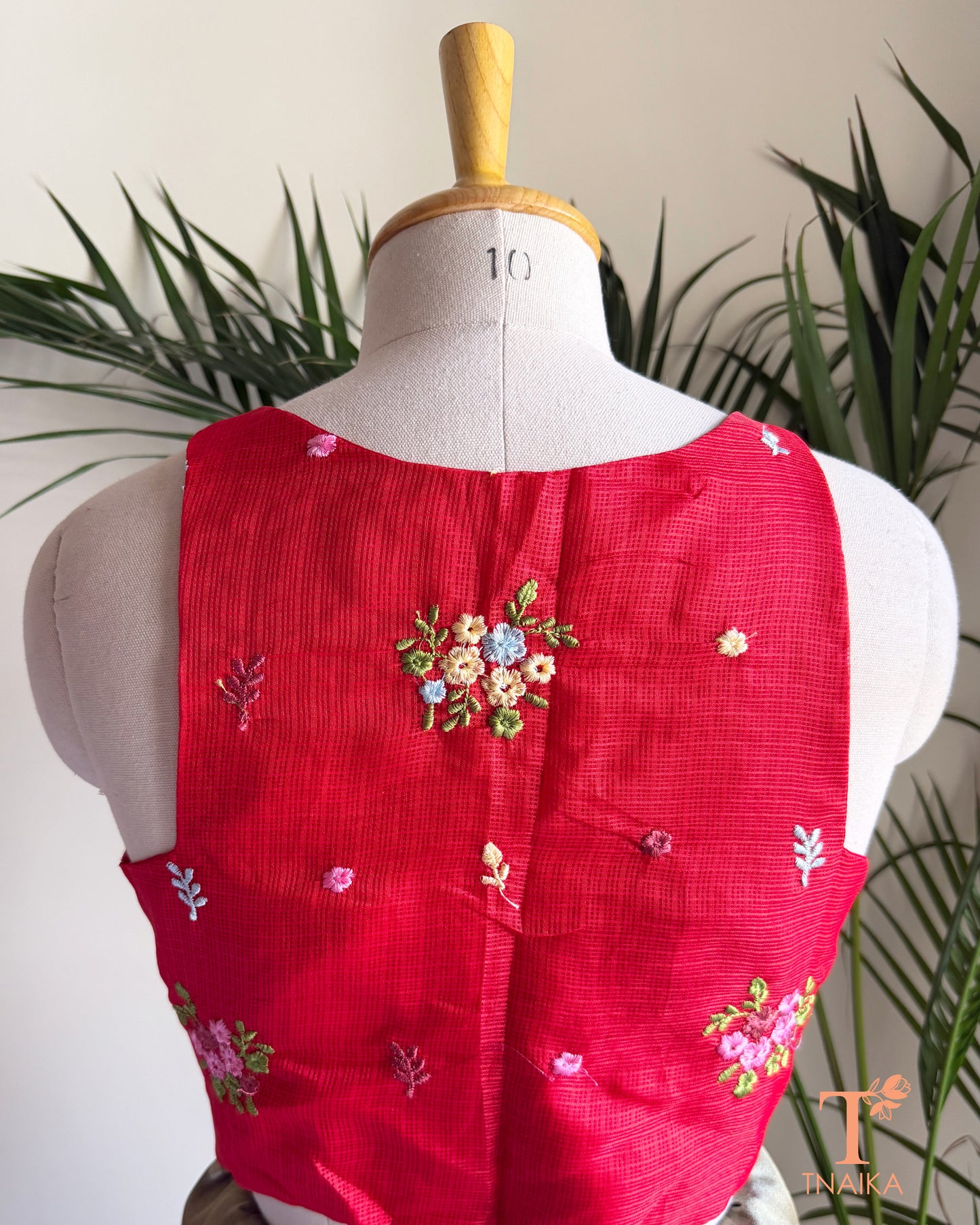 Back view of premium Kota silk blouse with delicate floral embroidery and elegant tailored finish.
