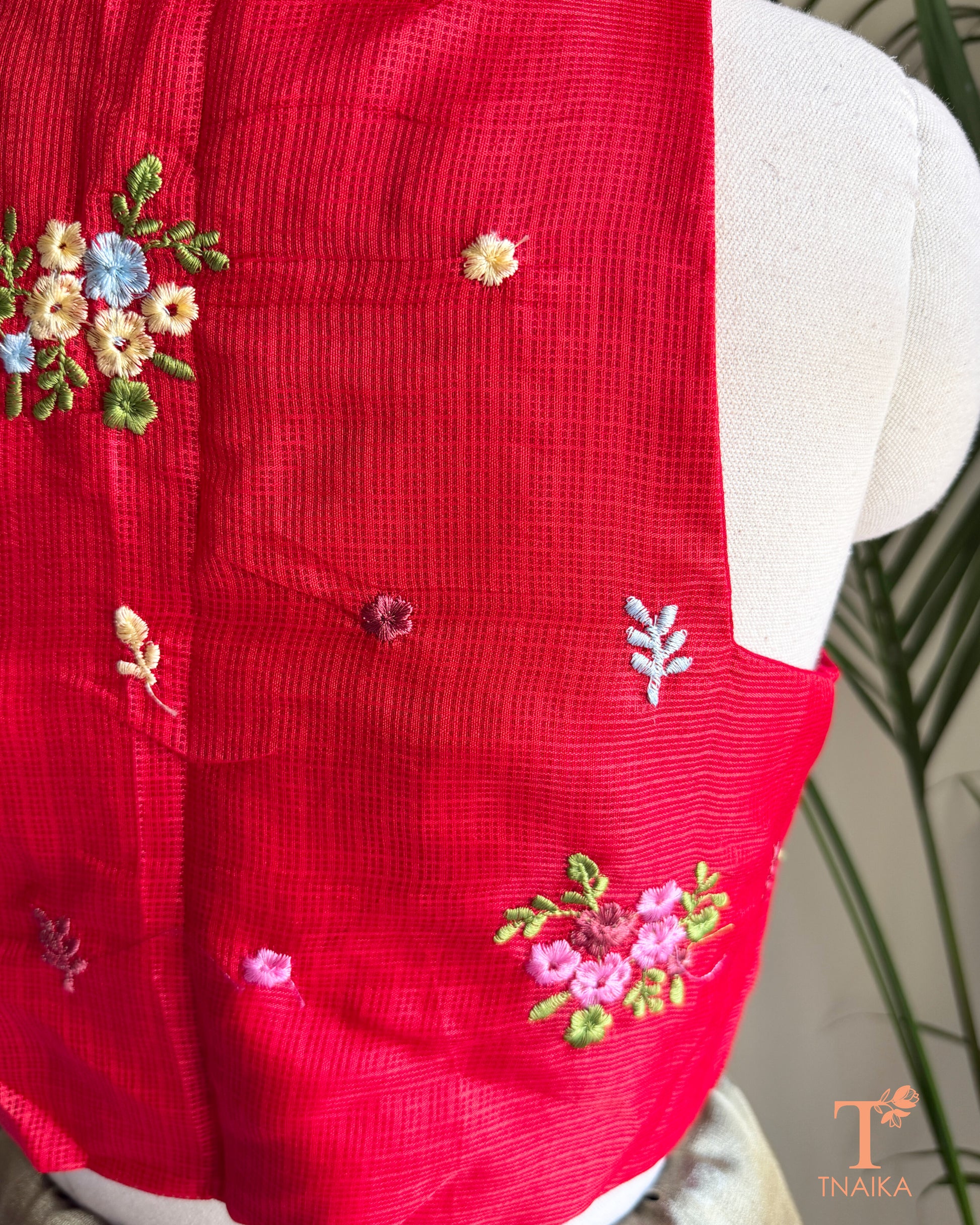 Close-up of floral embroidery detailing on premium Kota silk blouse showcasing handcrafted artistry.