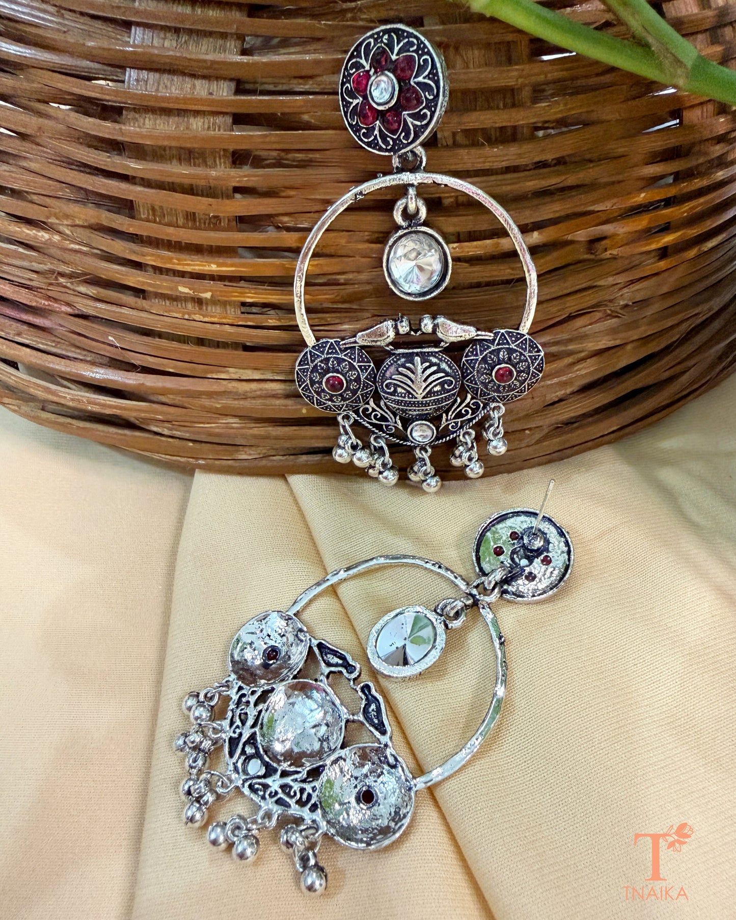 Traditional oxidised statement earrings featuring stones and dangling accents.