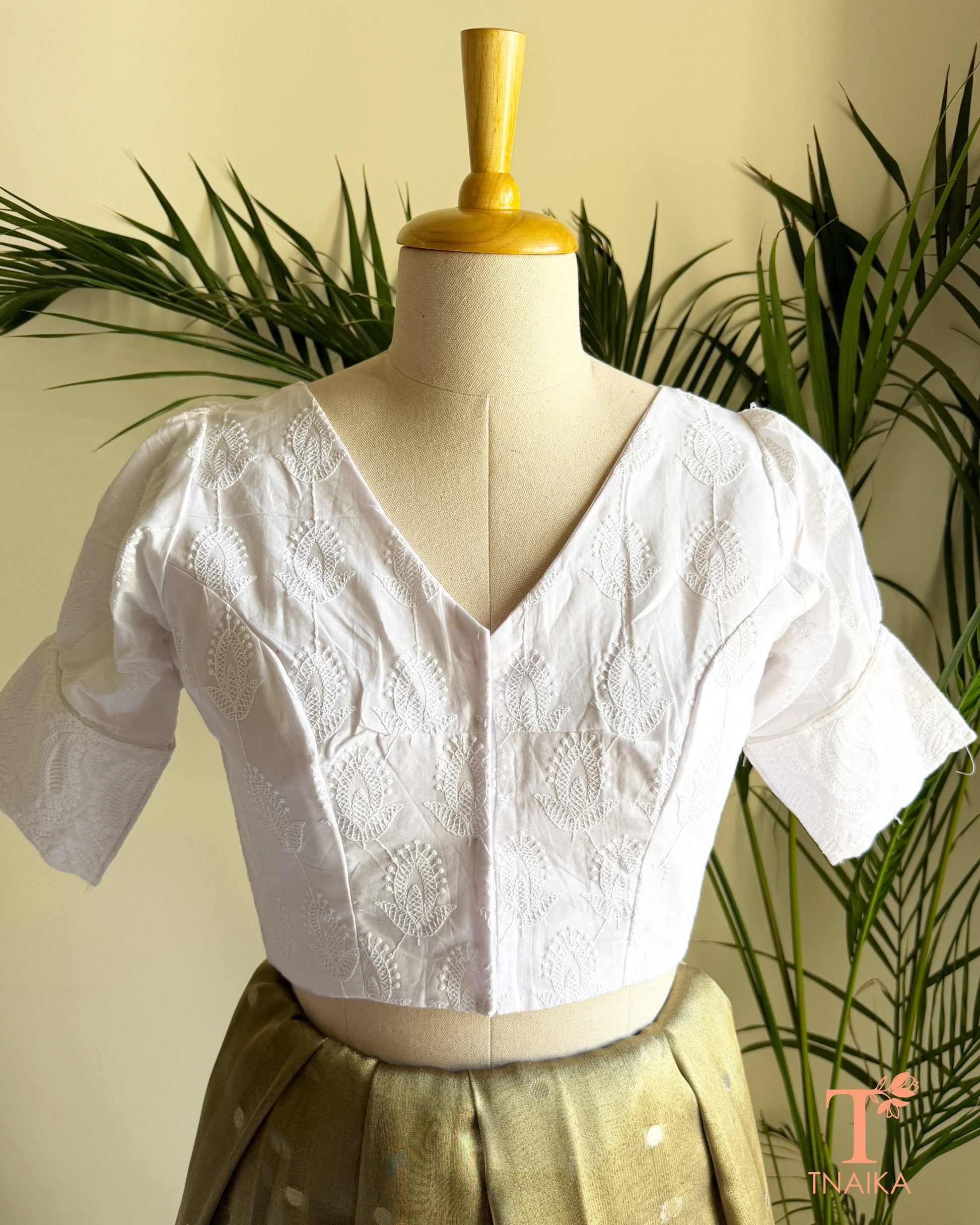 White Chikankari inspired cotton blouse with V-neck and puff sleeves front view.