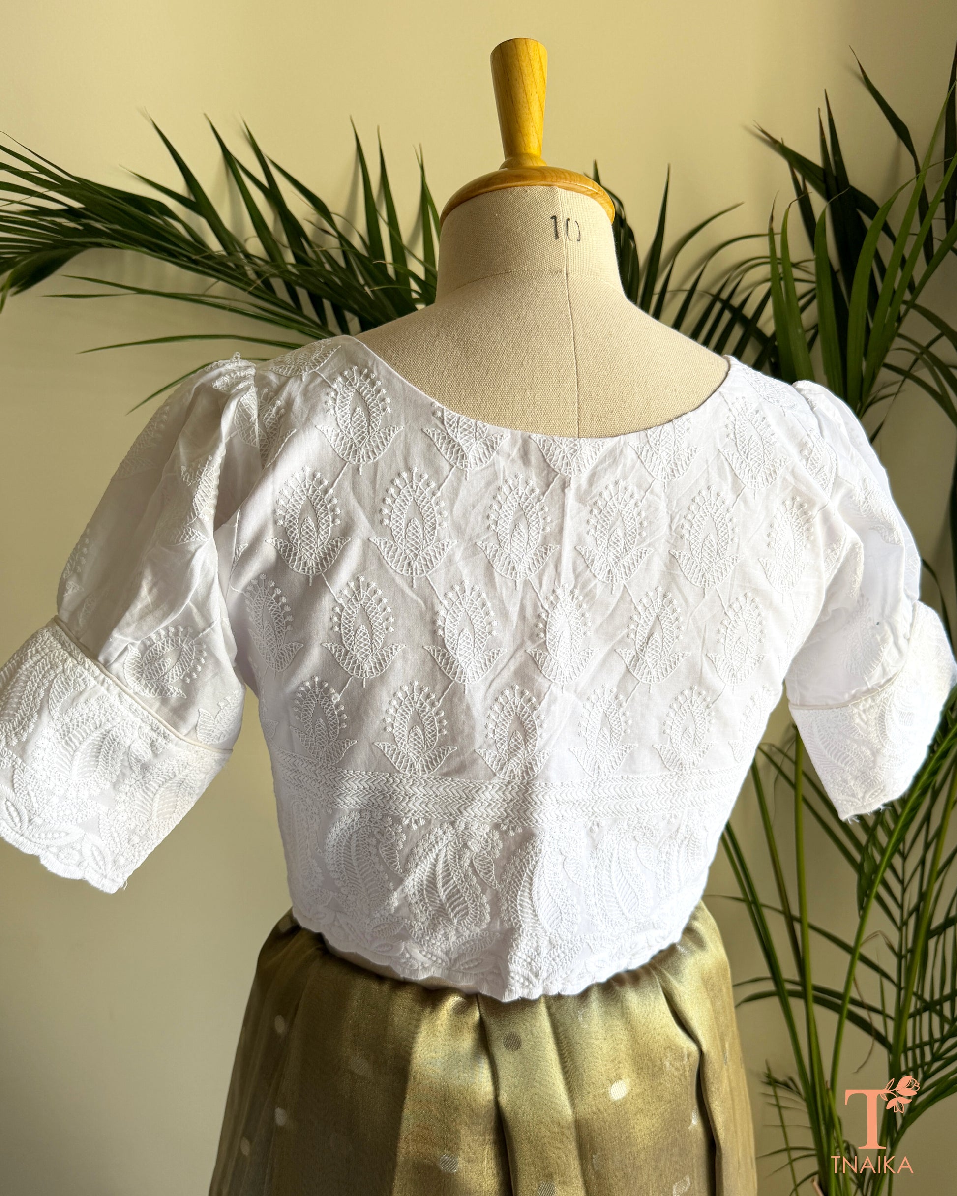 Back view of white embroidered cotton blouse featuring Bengali-style puff sleeves.