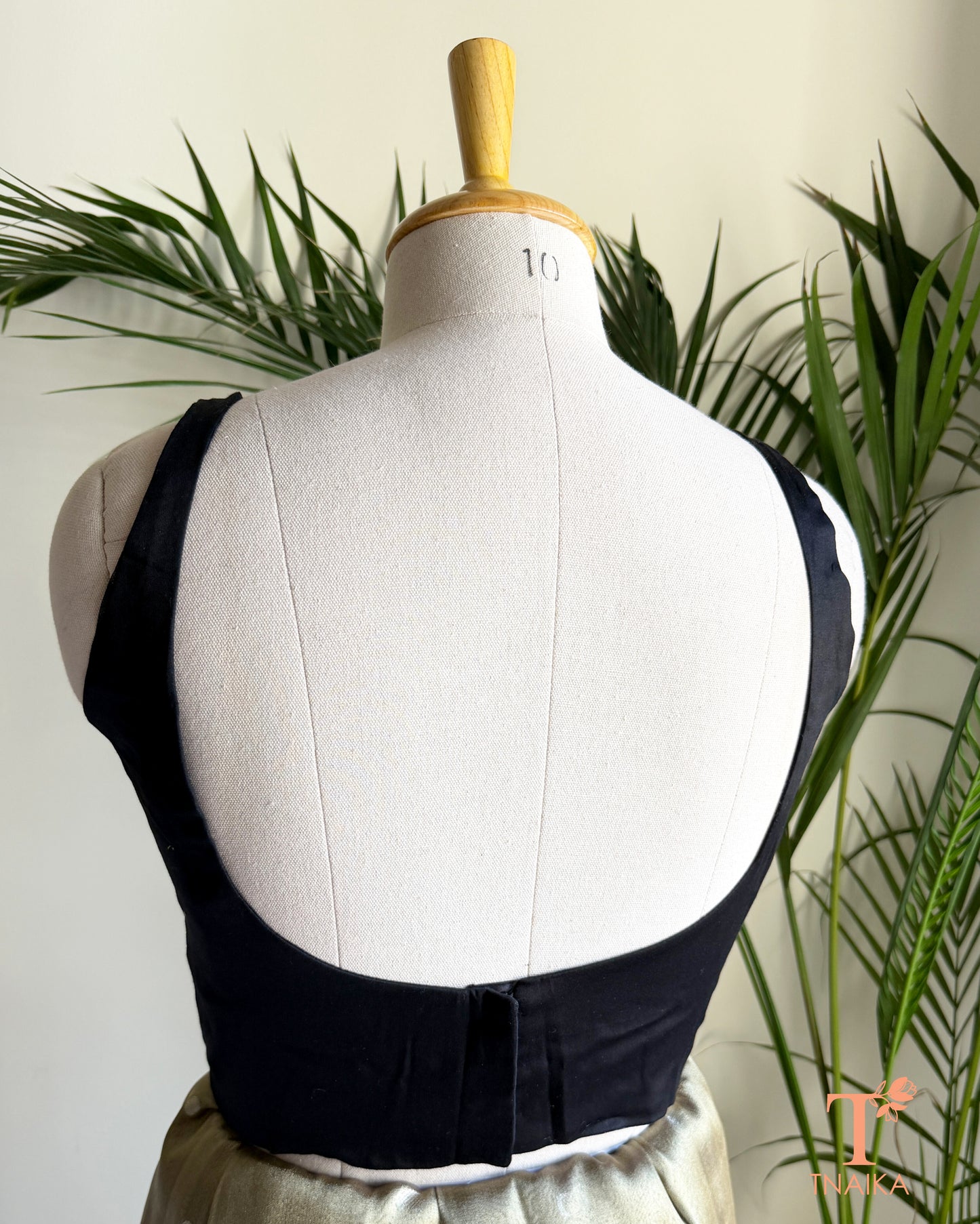 Back view of premium blouse featuring a deep U-shaped back and concealed hook closure.