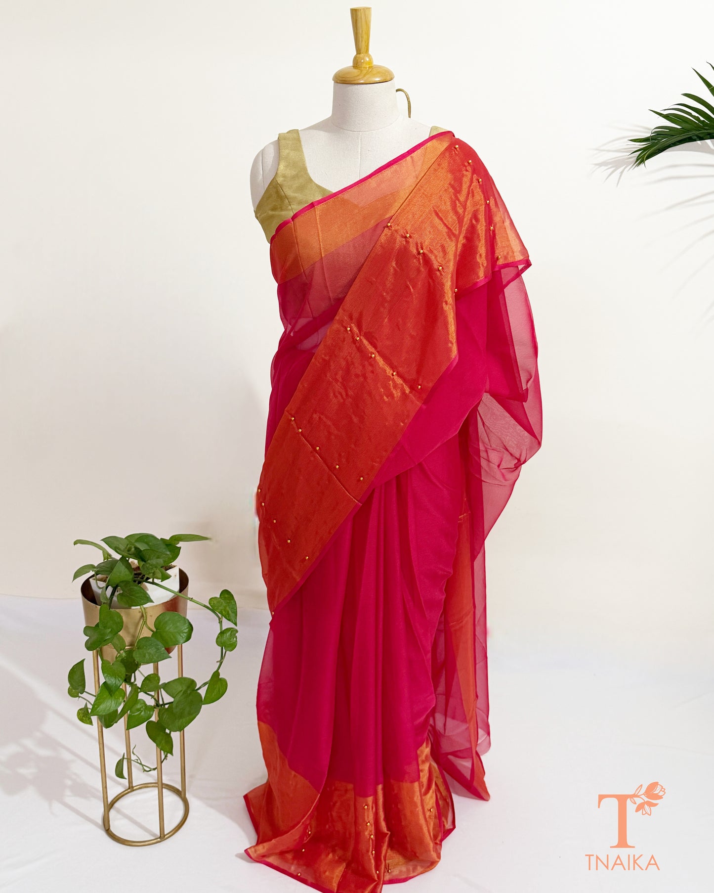 Elegant chiffon saree with shimmering golden border and soft drape.
