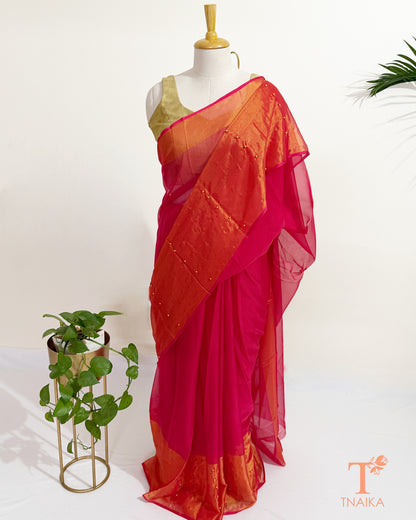 Elegant chiffon saree with shimmering golden border and soft drape.