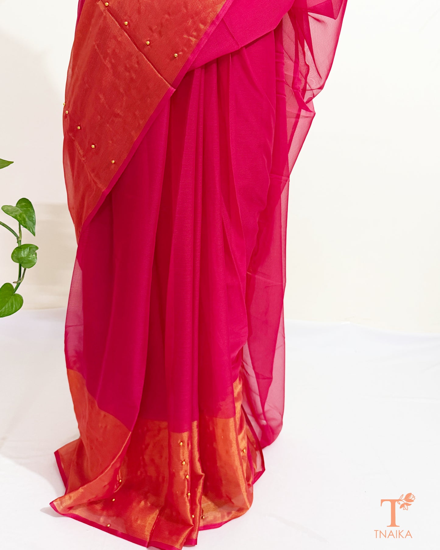Party wear chiffon saree with handcrafted pearl pin embellishments.