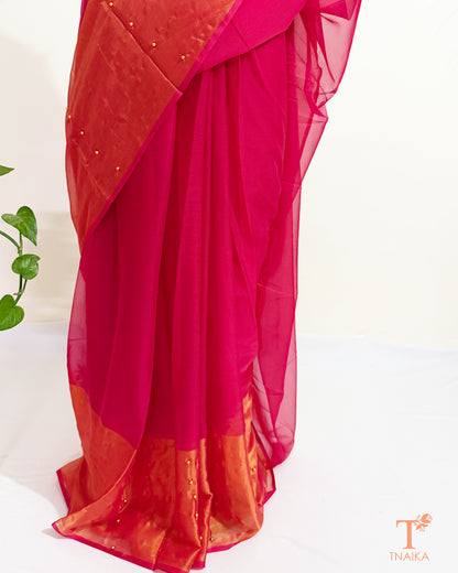 Party wear chiffon saree with handcrafted pearl pin embellishments.