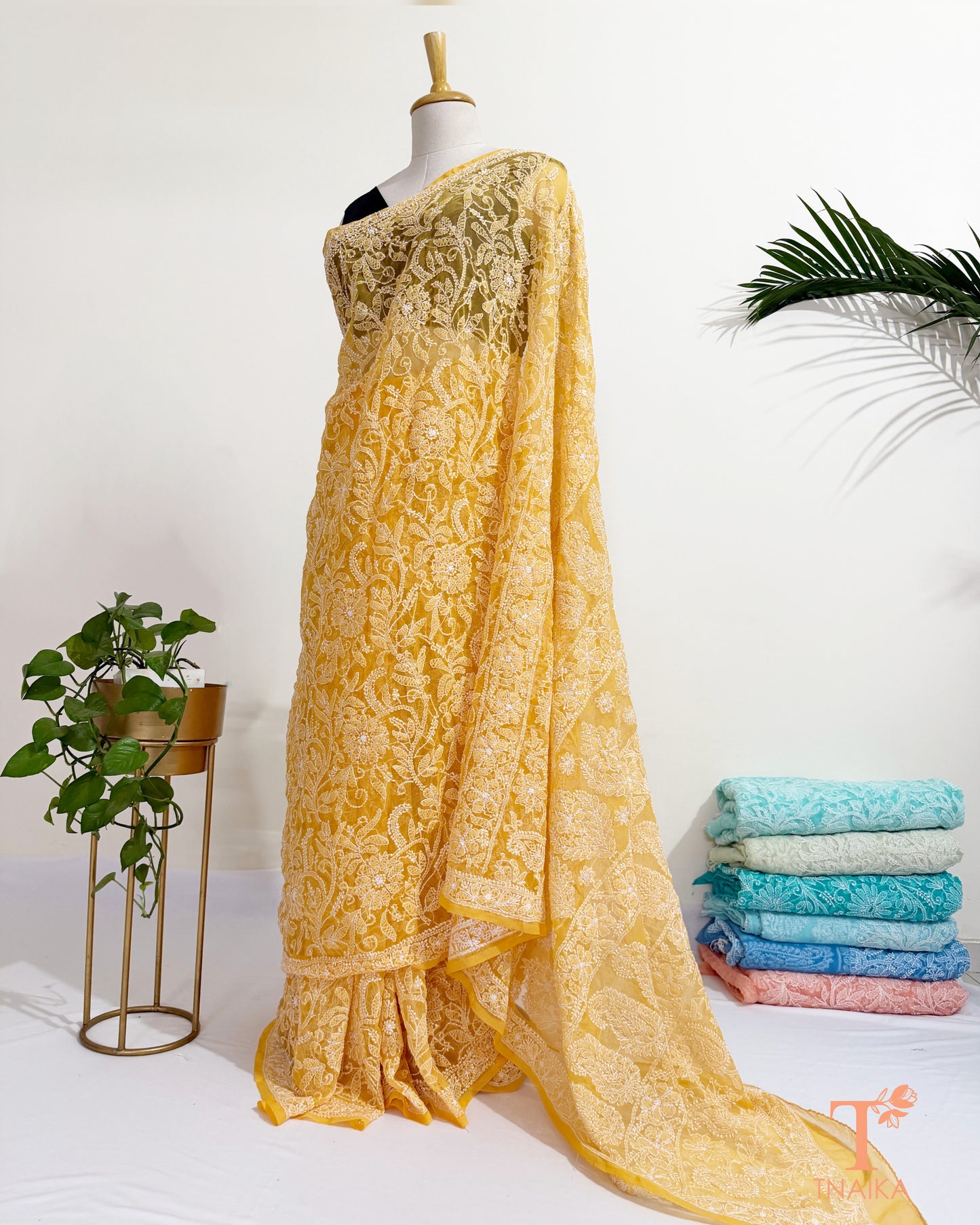 Lightweight embroidered yellow georgette saree with floral motifs.