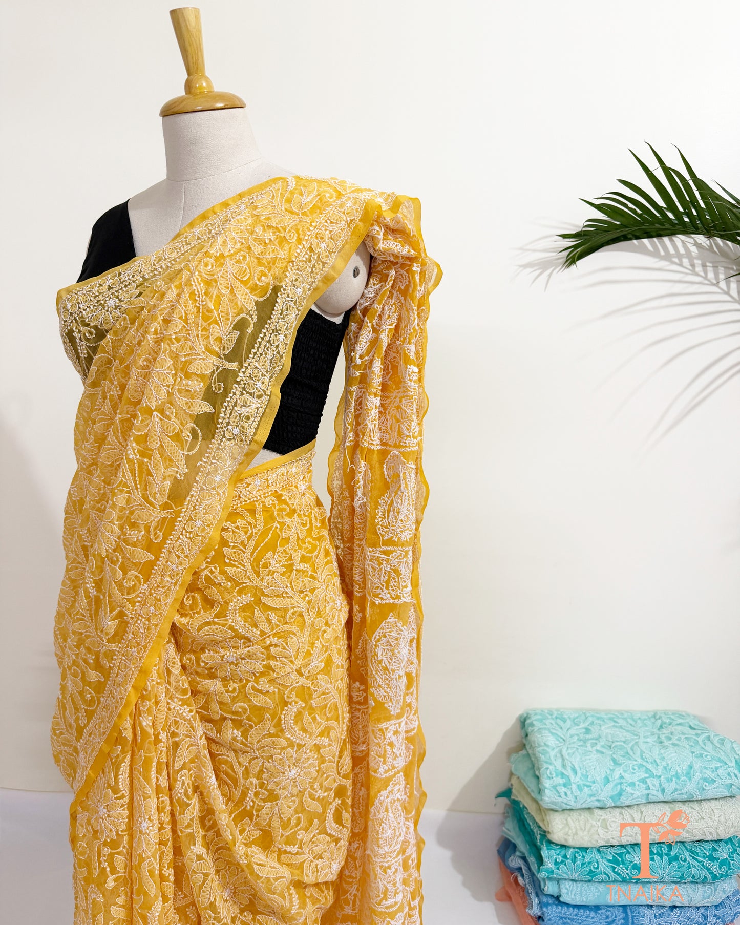 Yellow georgette saree with handcrafted paisley and floral embroidery.
