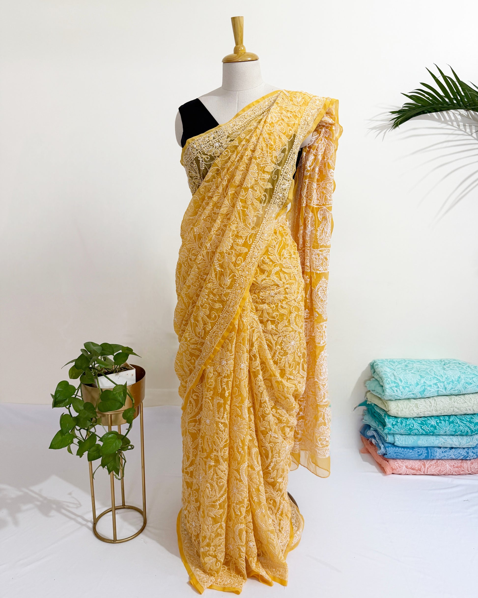 Soft flowy yellow georgette saree with traditional Chikankari craftsmanship.