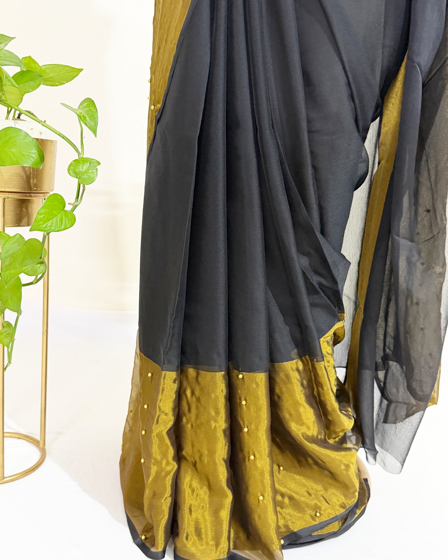 Lightweight black chiffon saree with sheer pallu and tissue border.