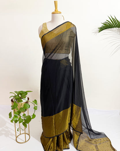 Elegant pearl pinned chiffon saree featuring a metallic gold border.
