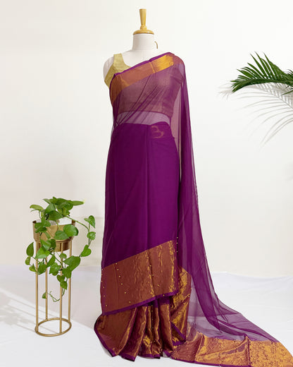 Premium chiffon saree with antique gold border for festive wear.