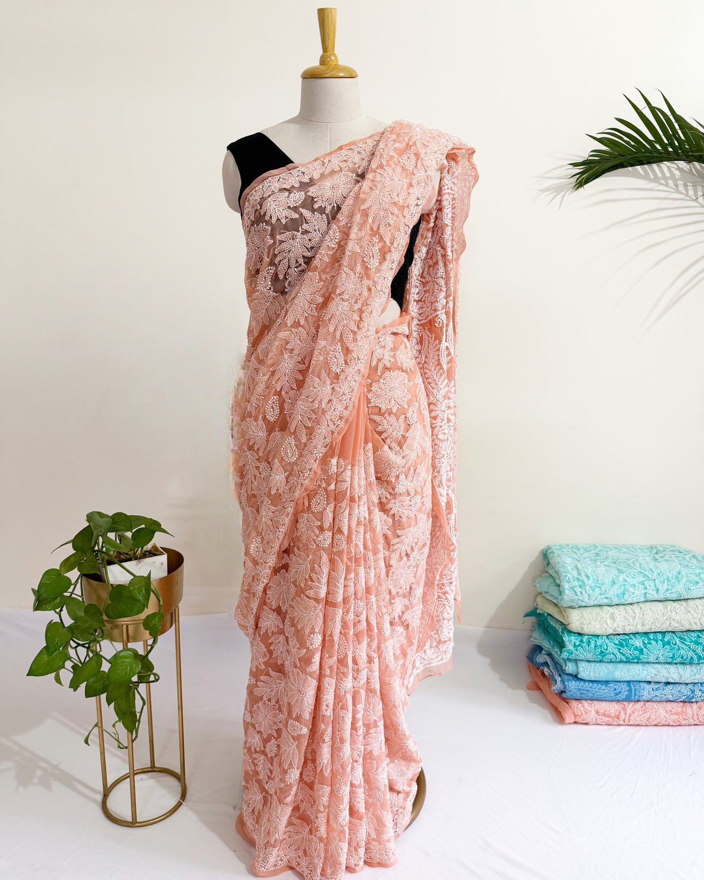 Blush peach embroidered Chikankari saree showcasing traditional Lucknowi floral threadwork.