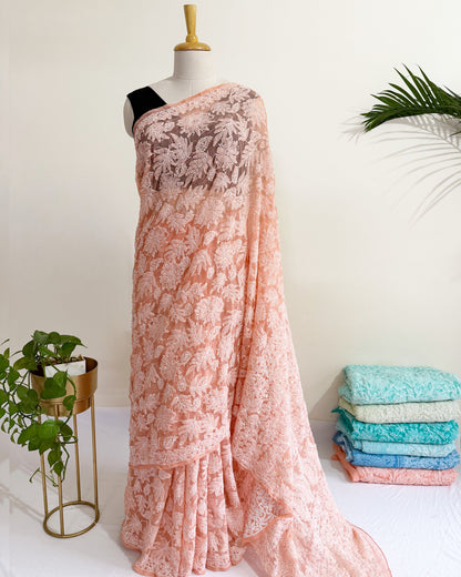 Blush peach Chikankari saree with intricate full jaal floral embroidery and elegant handcrafted detailing.
