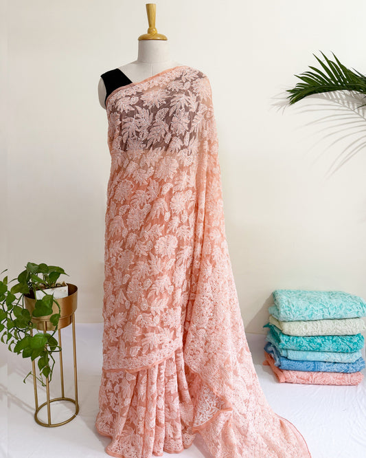 Blush peach Chikankari saree with intricate full jaal floral embroidery and elegant handcrafted detailing.