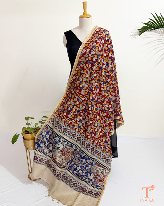 Premium Nellore silk blend hand block Kalamkari dupatta featuring traditional artisan prints, fine zari border and tassel finish.