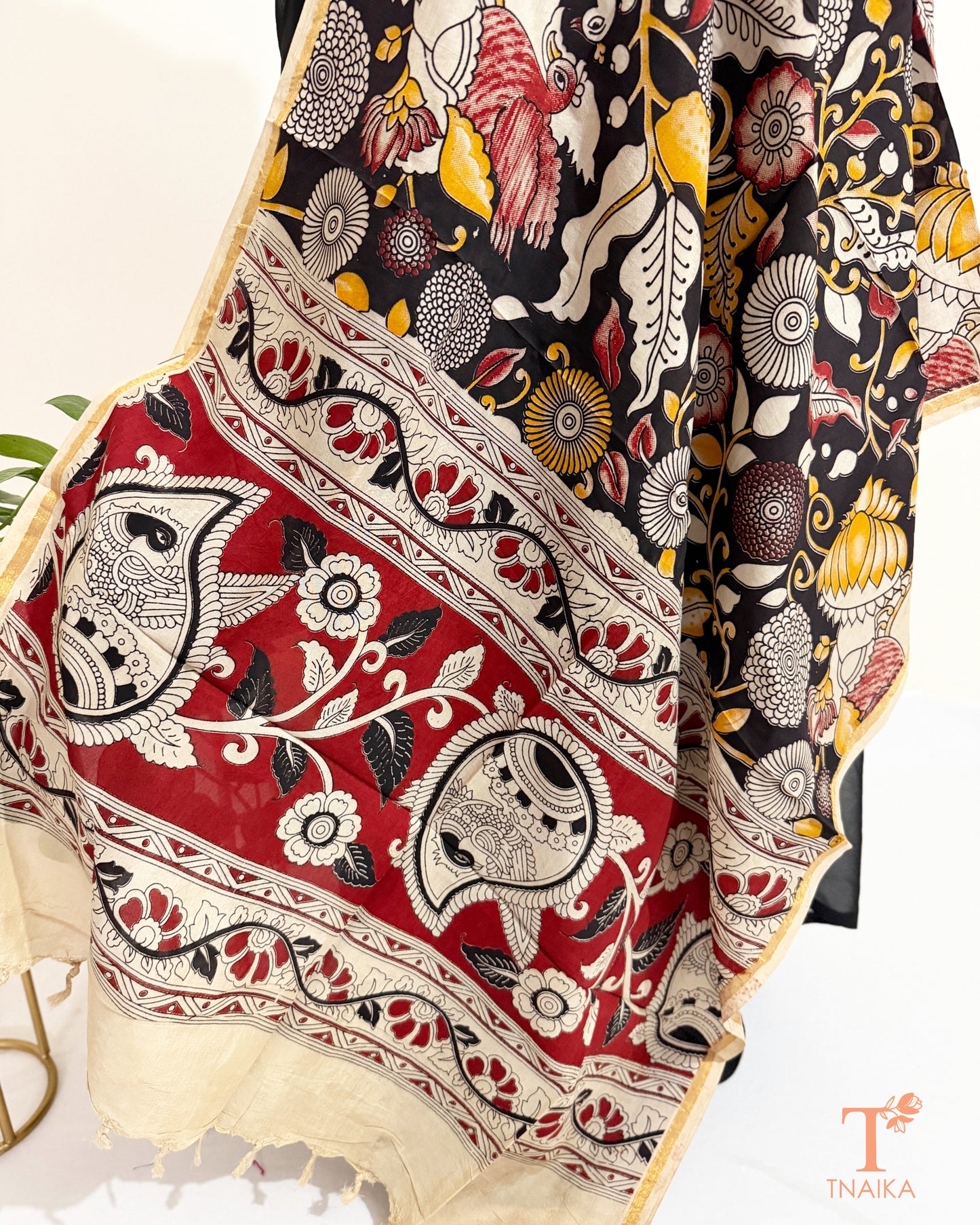 Premium Nellore silk blend hand block Kalamkari dupatta featuring traditional artisan prints, fine zari border and tassel finish.