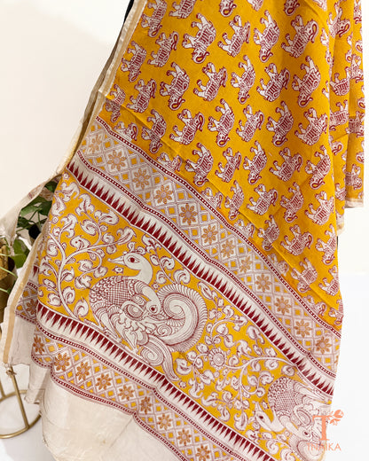 Premium Nellore silk blend hand block Kalamkari dupatta featuring traditional artisan prints, fine zari border and tassel finish.