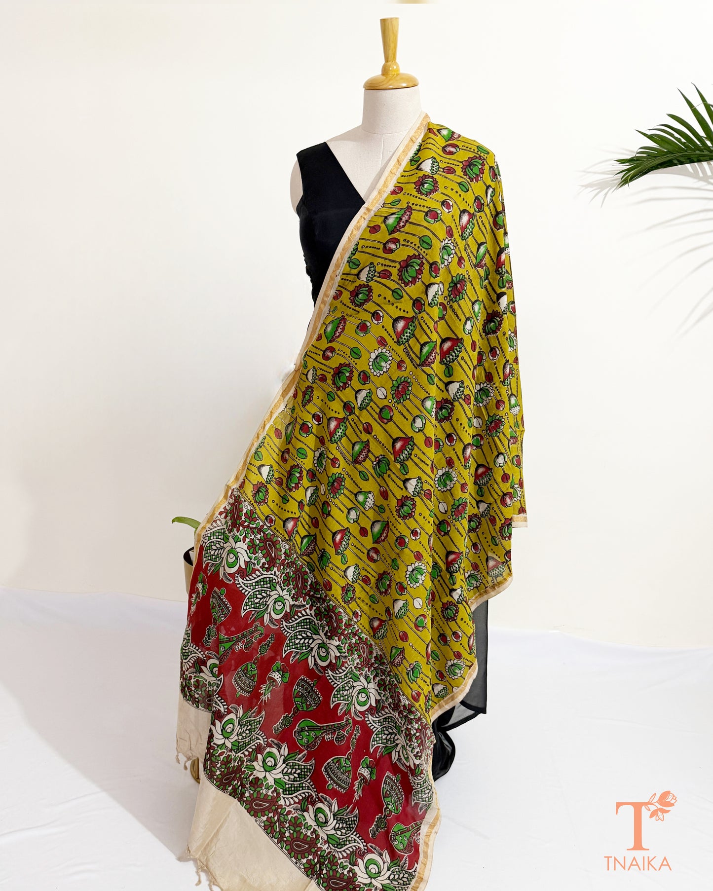 Premium Nellore silk blend hand block Kalamkari dupatta featuring traditional artisan prints, fine zari border and tassel finish.
