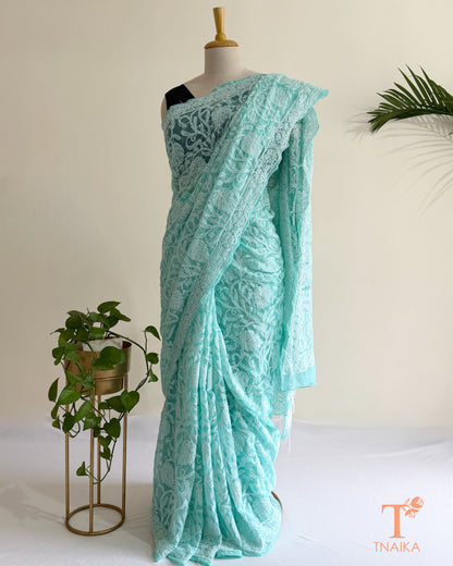 Premium soft aqua Chikankari saree featuring handcrafted floral embroidery