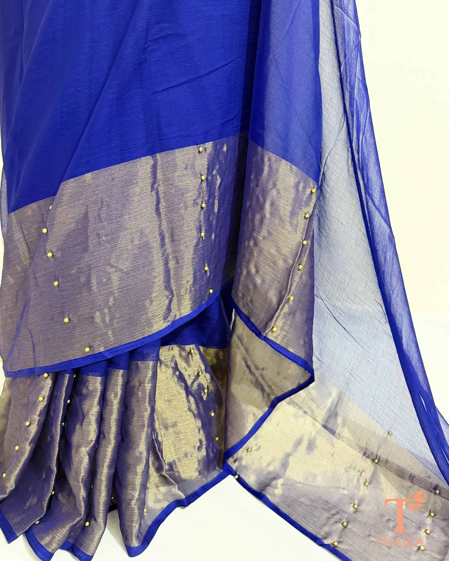 Lightweight chiffon saree with sheer pallu and tissue border.