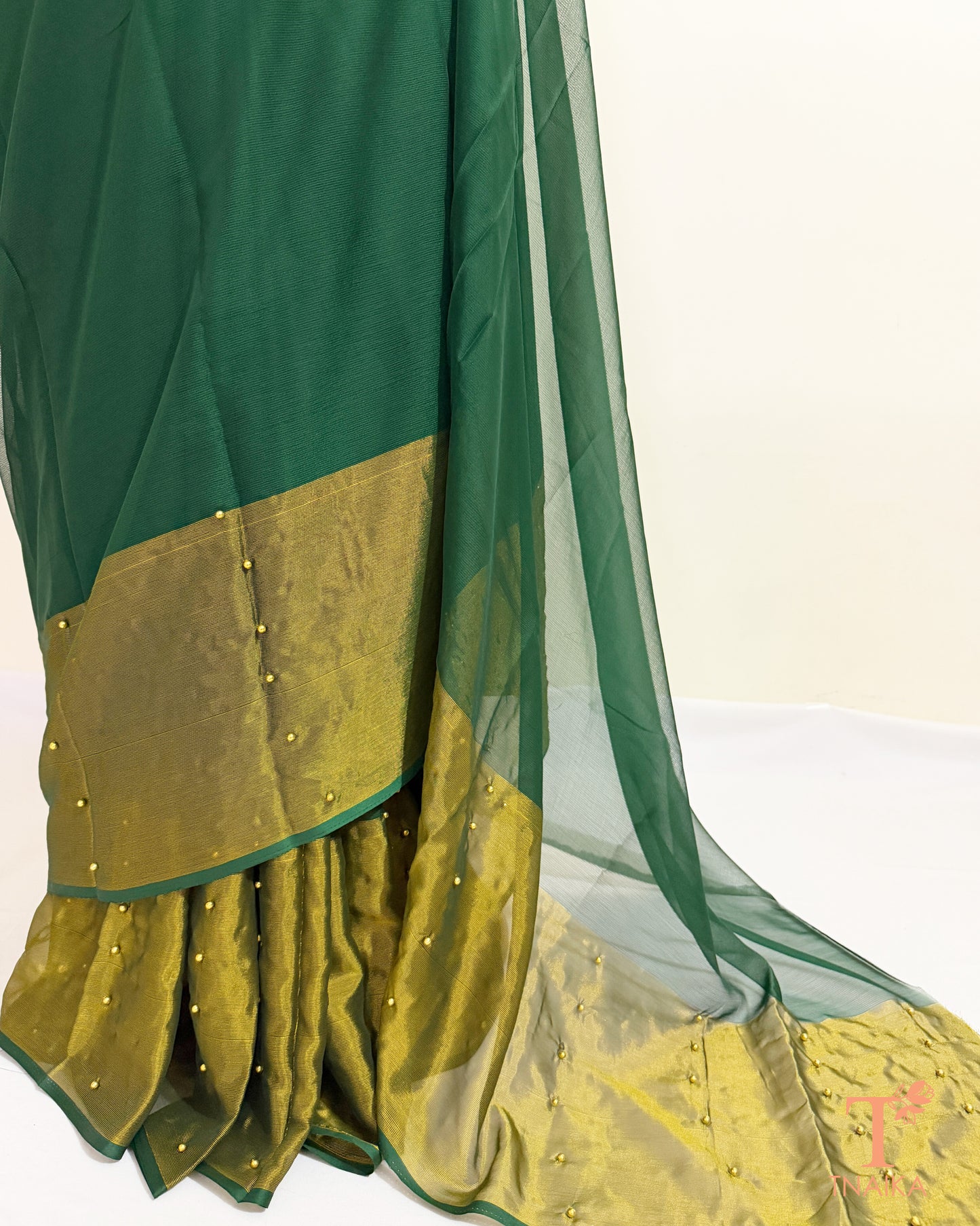Lightweight chiffon saree with sheer pallu and tissue border.