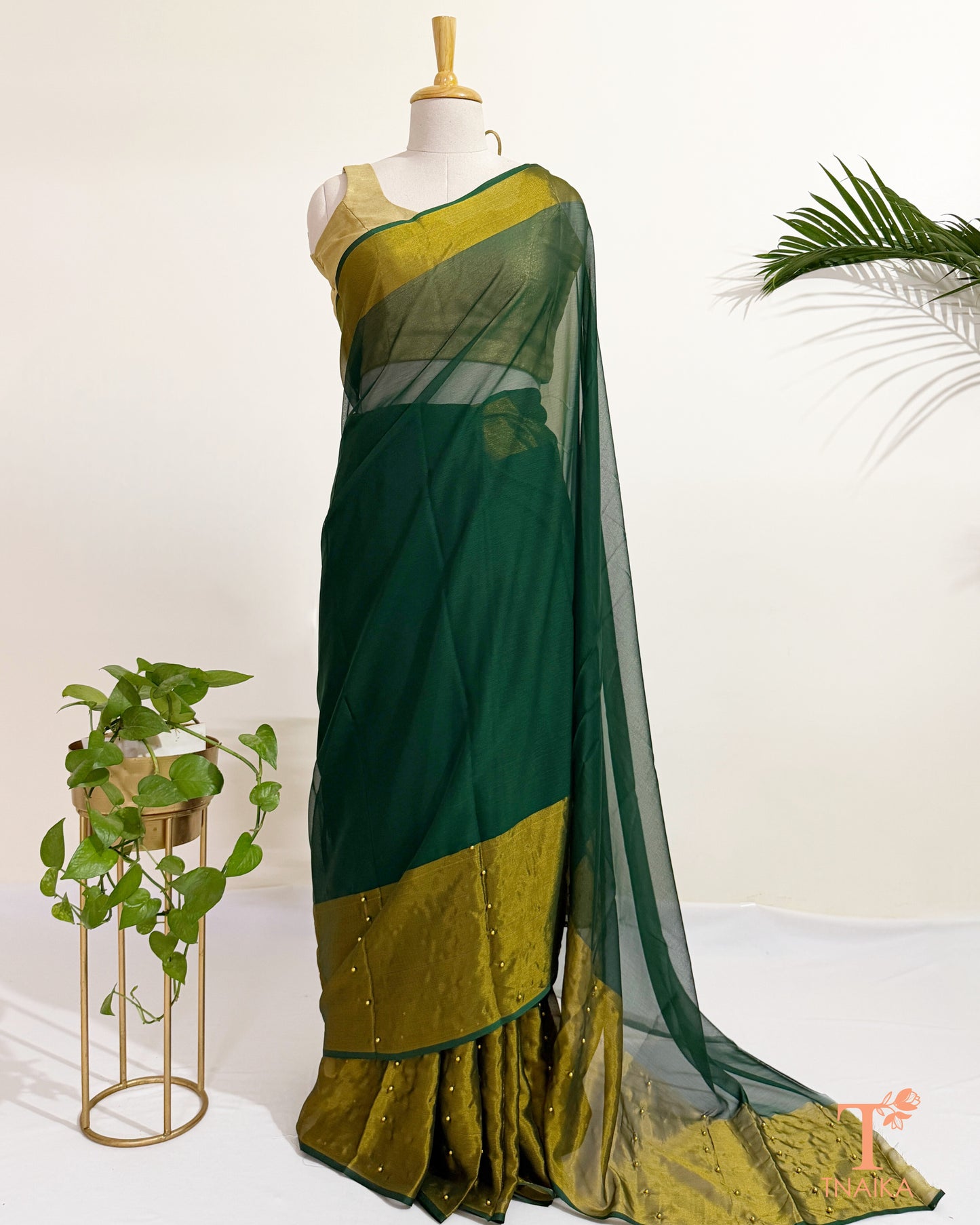 Premium chiffon saree with antique gold border for festive wear.
