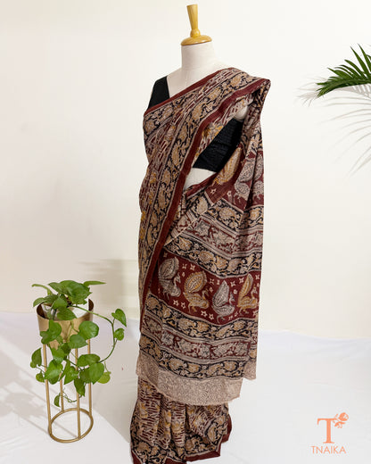 Hand blocked Kalamkari saree with traditional floral motifs and artisan-crafted detailing.