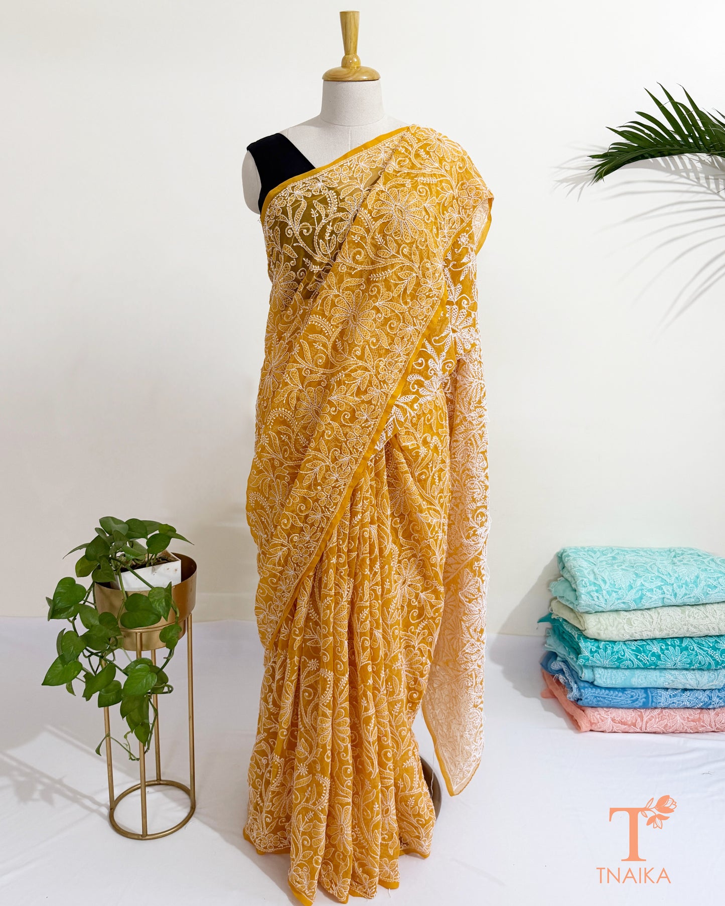Lightweight embroidered mustard georgette saree with floral motifs.