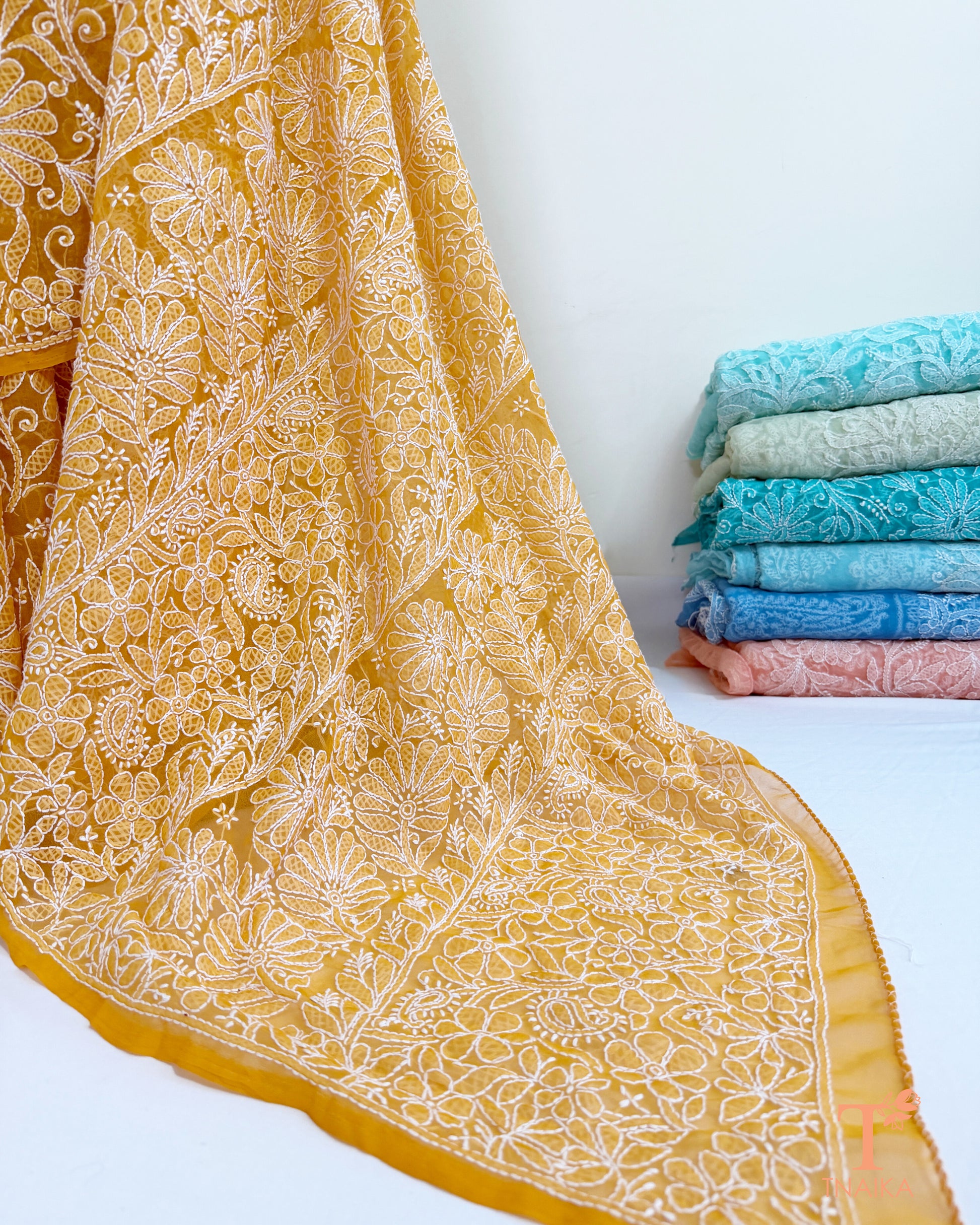 Elegant mustard yellow Chikankari saree featuring detailed embroidered pallu.