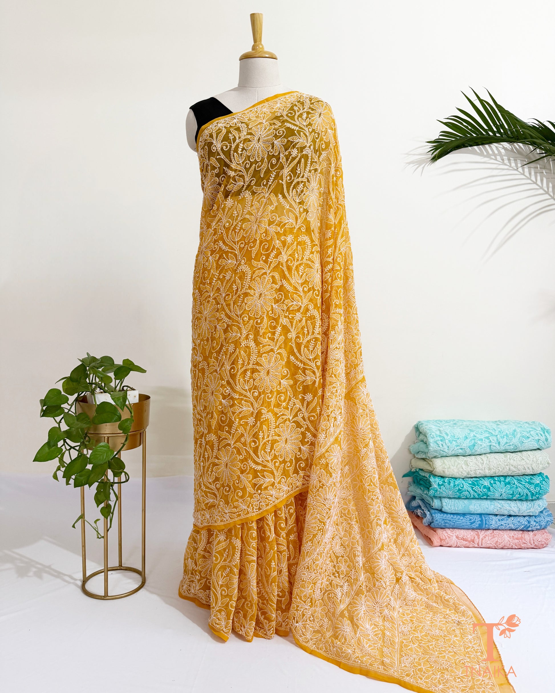 Festive yellow Chikankari saree with richly embroidered border.