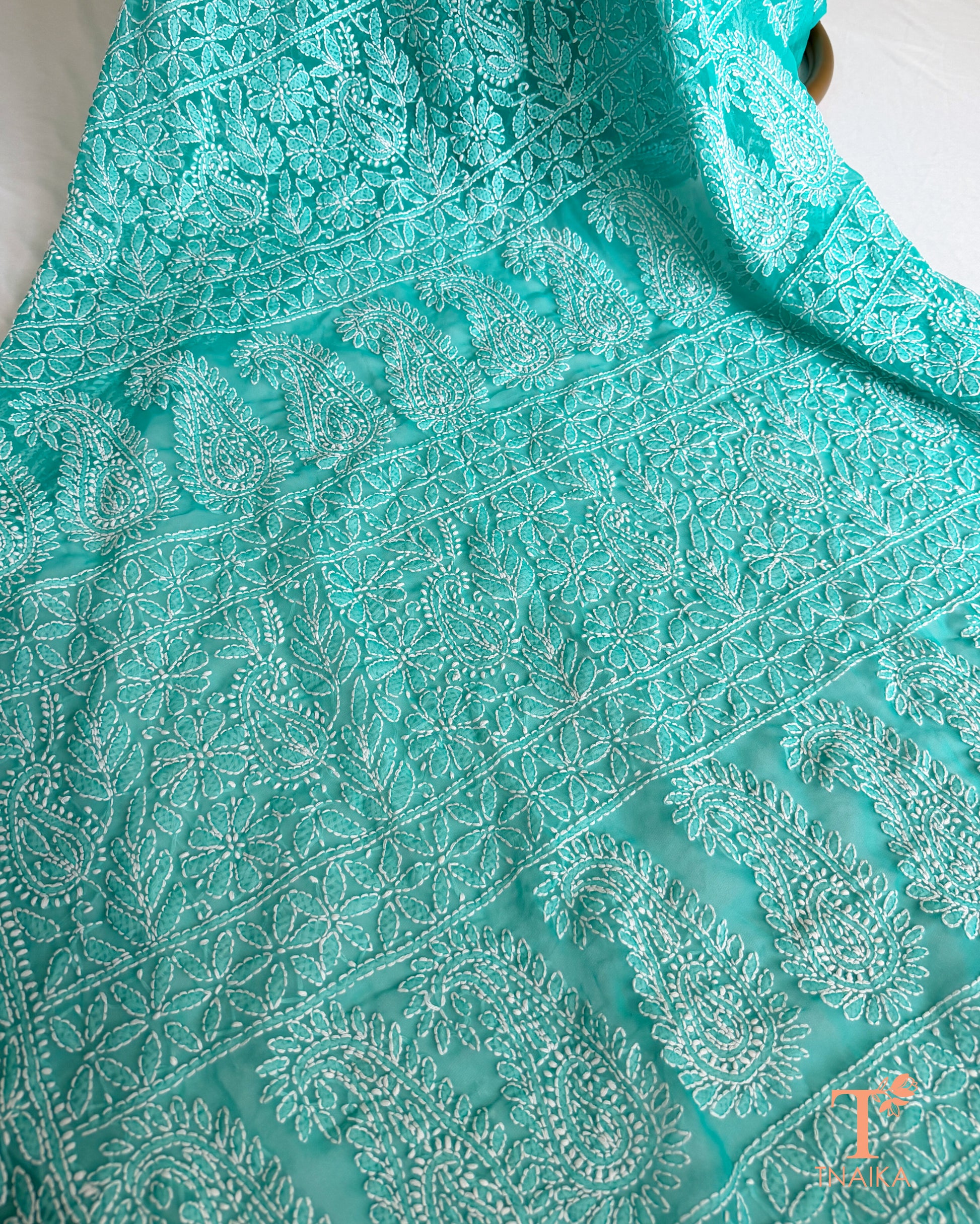 Soft turquoise teal embroidered Chikankari saree featuring traditional Lucknowi white thread craftsmanship.