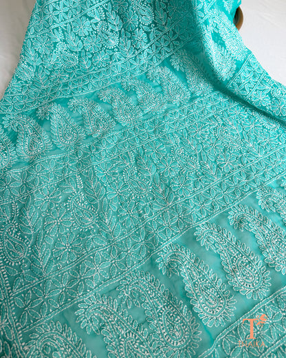 Soft turquoise teal embroidered Chikankari saree featuring traditional Lucknowi white thread craftsmanship.
