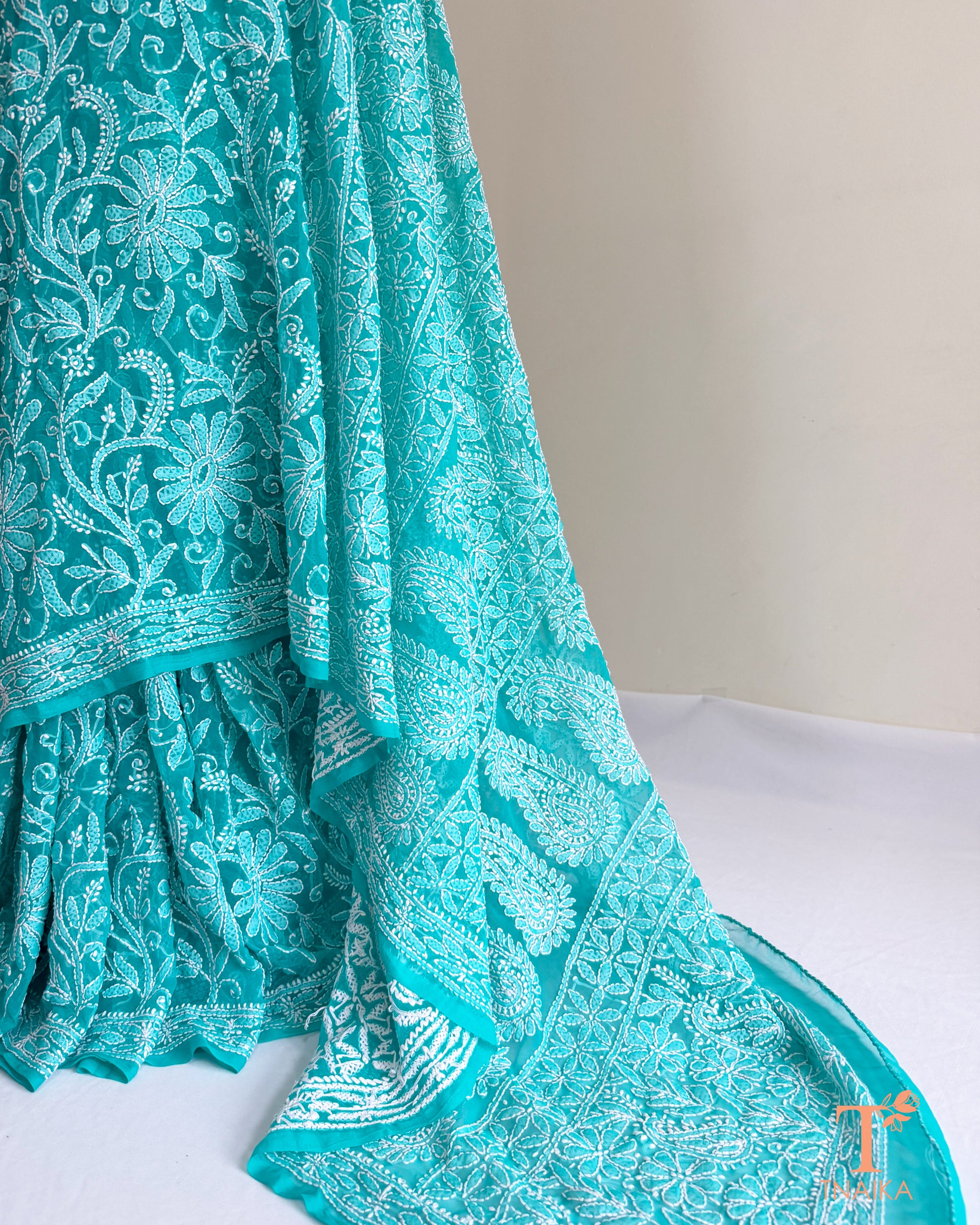 Luxury turquoise teal Chikankari saree with floral vine embroidery and finely finished embroidered borders.