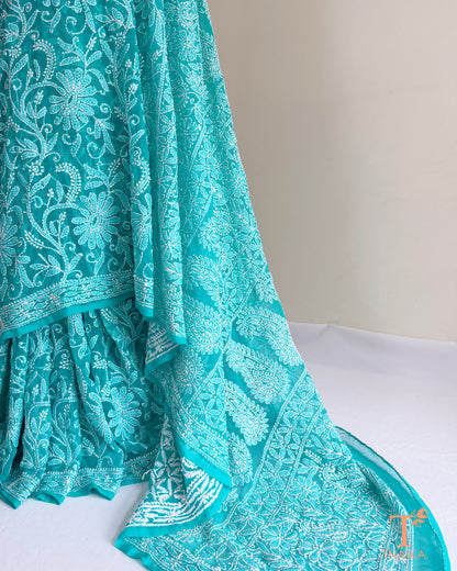 Luxury turquoise teal Chikankari saree with floral vine embroidery and finely finished embroidered borders.