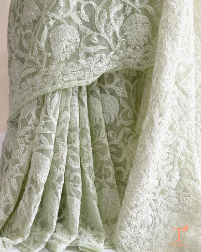 Elegant mint green Chikankari saree featuring handcrafted white floral embroidery and richly embroidered pallu.