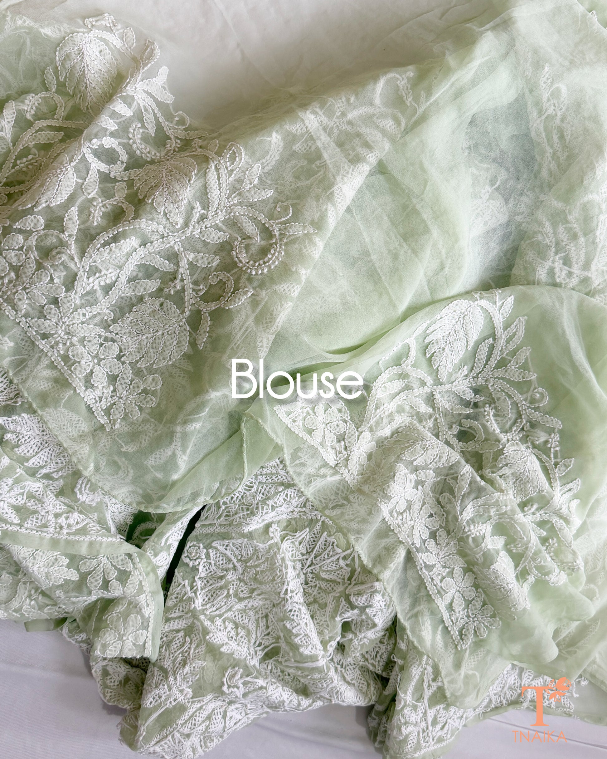 Luxury mint green Chikankari saree adorned with floral vine embroidery and exquisite Lucknowi craftsmanship.