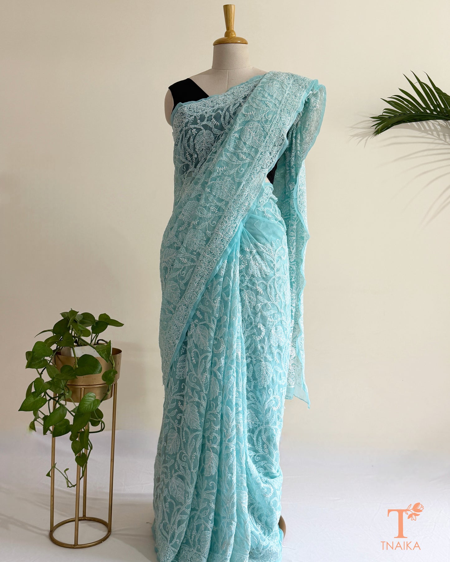Elegant ice blue Chikankari saree with all-over white floral embroidery and delicate handcrafted detailing.