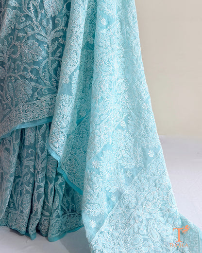 Aqua blue embroidered Chikankari saree showcasing traditional Lucknowi craftsmanship with intricate floral jaal.