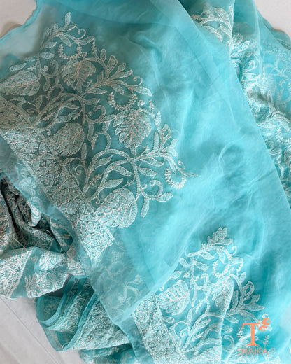 Designer aqua blue Lucknowi Chikankari saree with intricate white thread embroidery and timeless floral craftsmanship.