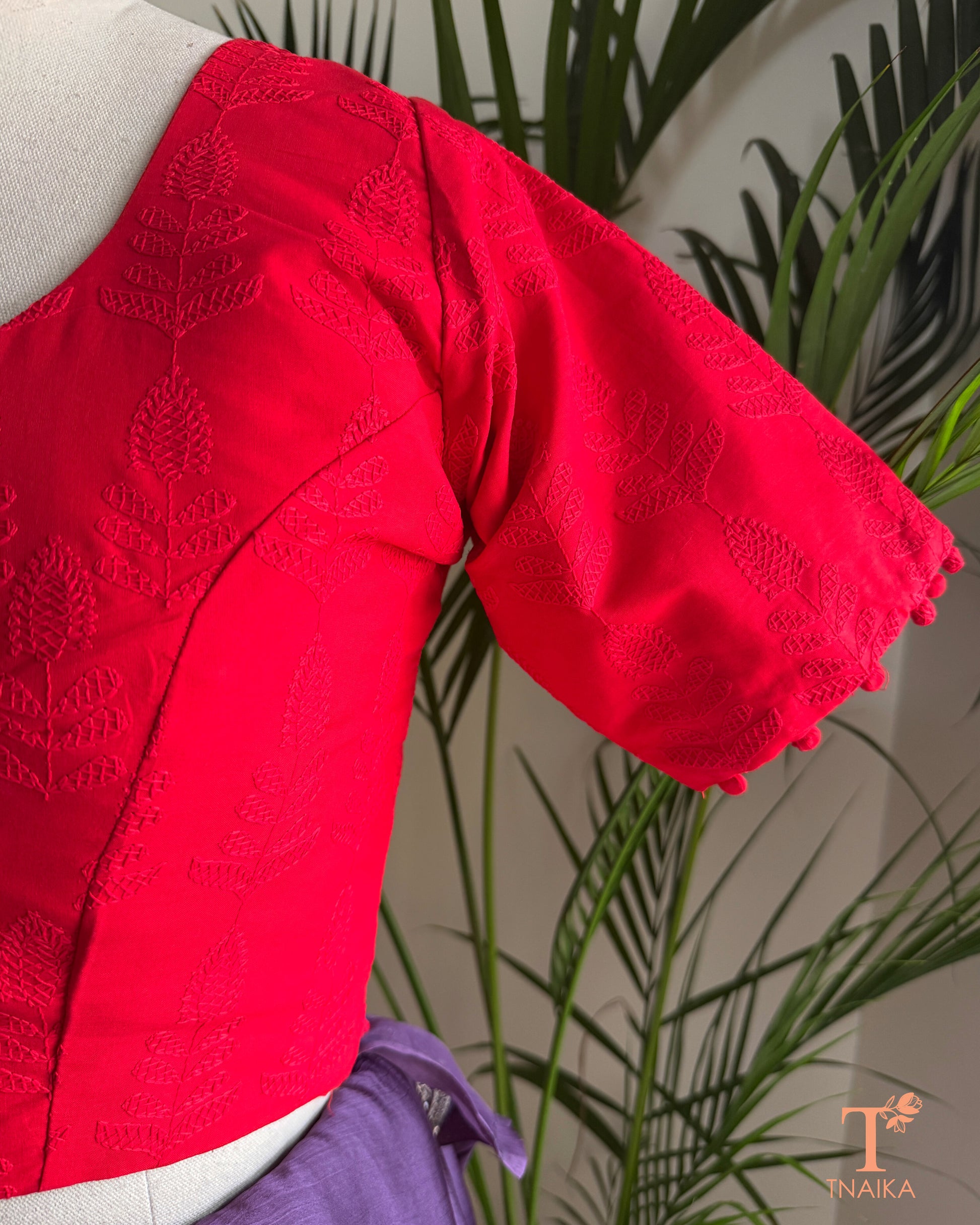 Red Chikankari embroidered blouse with tonal floral machine embroidery and potli button sleeves.