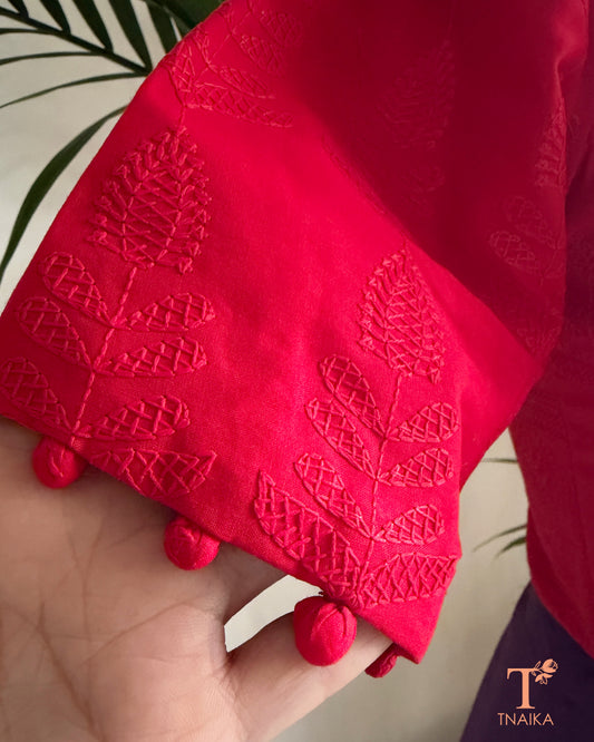 Classic red embroidered blouse featuring machine Chikankari work and decorative potli button sleeve detailing.