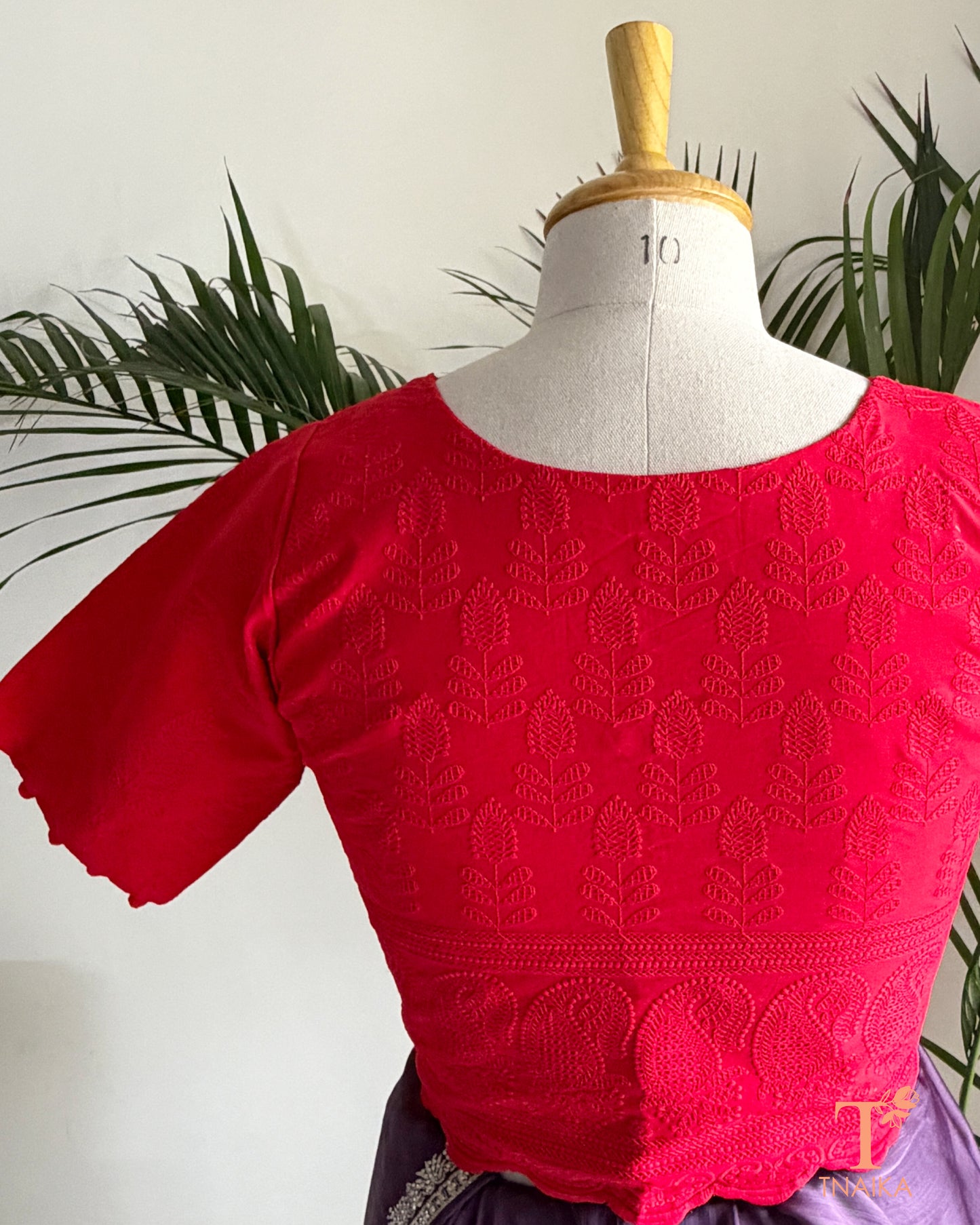 Premium red ethnic blouse with tonal Chikankari embroidery and handcrafted-style potli button sleeves.