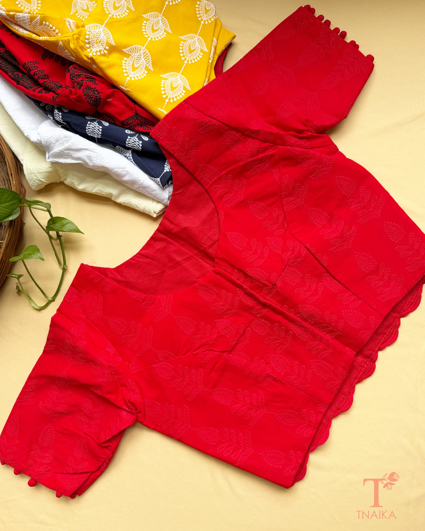 Elegant red machine embroidered Chikankari blouse with floral motifs and potli button sleeve accents.